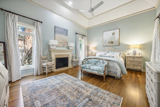 bedroom featuring dark hardwood / wood-style flooring, ornamental molding, a towering ceiling, and ceiling fan