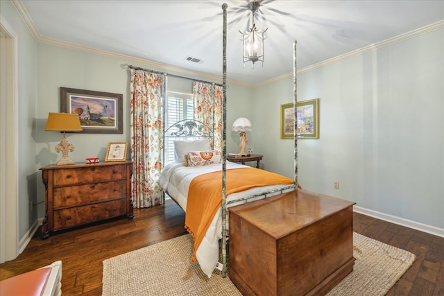 bedroom with ornamental molding, an inviting chandelier, and dark hardwood / wood-style floors