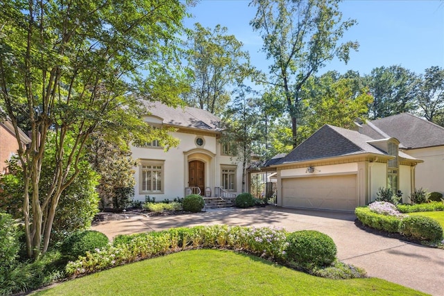 view of front of house featuring a front yard and a garage