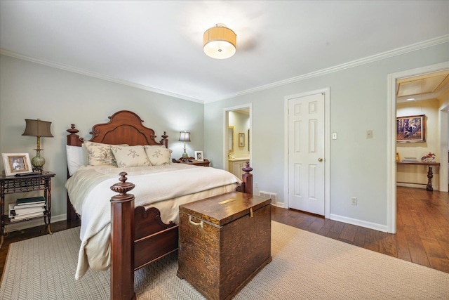 bedroom featuring connected bathroom, crown molding, and dark hardwood / wood-style flooring