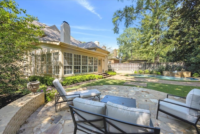 view of patio / terrace featuring an outdoor living space and a fenced in pool