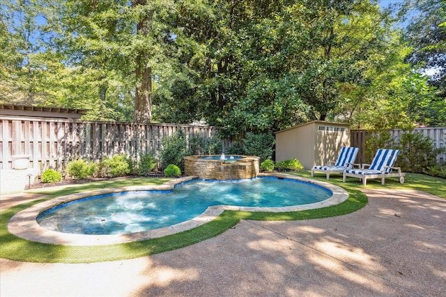 view of pool with a storage shed, pool water feature, a patio, and an in ground hot tub