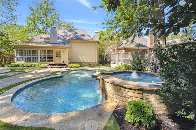 view of pool with a patio, pool water feature, and an in ground hot tub