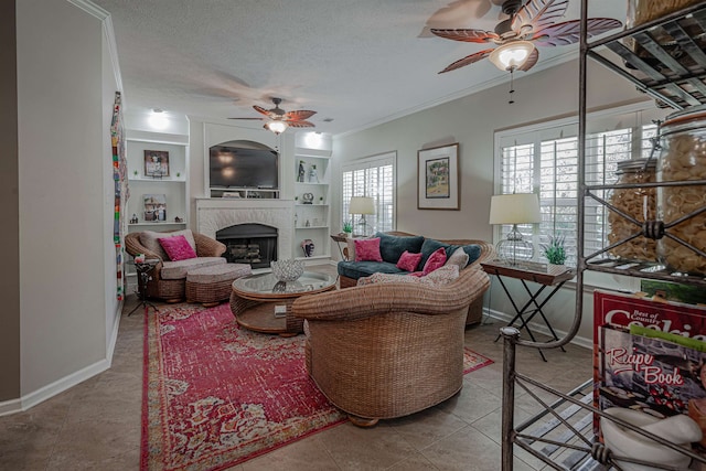 tiled living room featuring ceiling fan, a textured ceiling, and ornamental molding