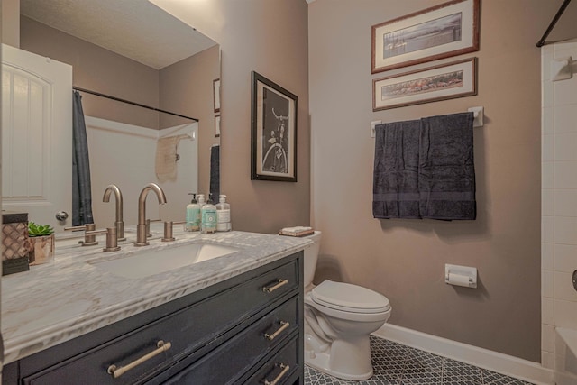 bathroom with tile patterned floors, vanity, and toilet