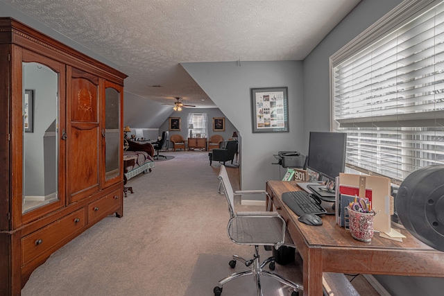 office featuring a textured ceiling, light colored carpet, and ceiling fan