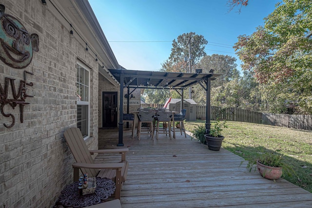 wooden deck featuring a pergola, a lawn, and a storage shed