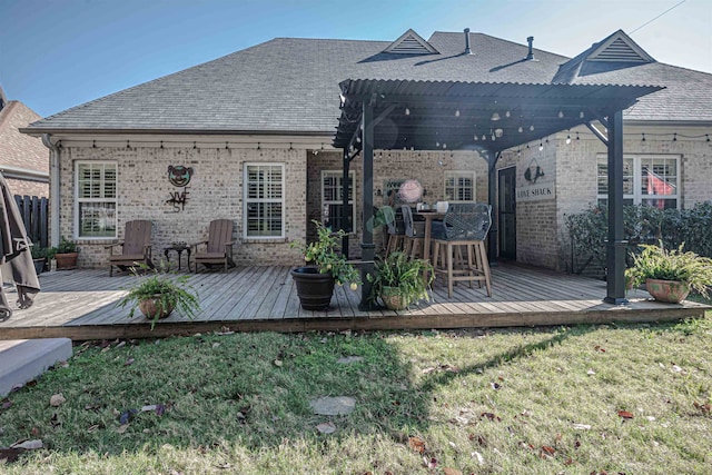 wooden deck featuring a pergola and a yard