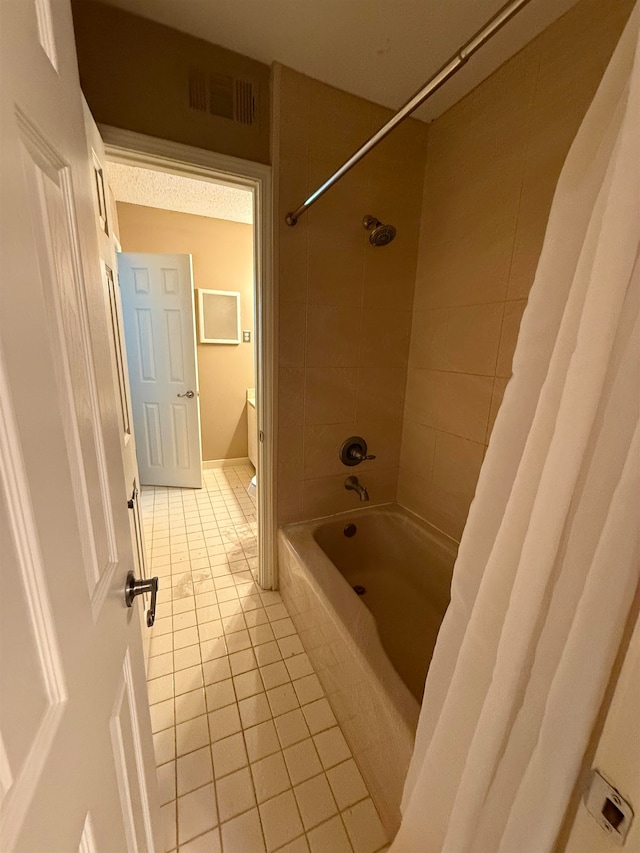 bathroom featuring shower / bath combination with curtain and tile patterned floors