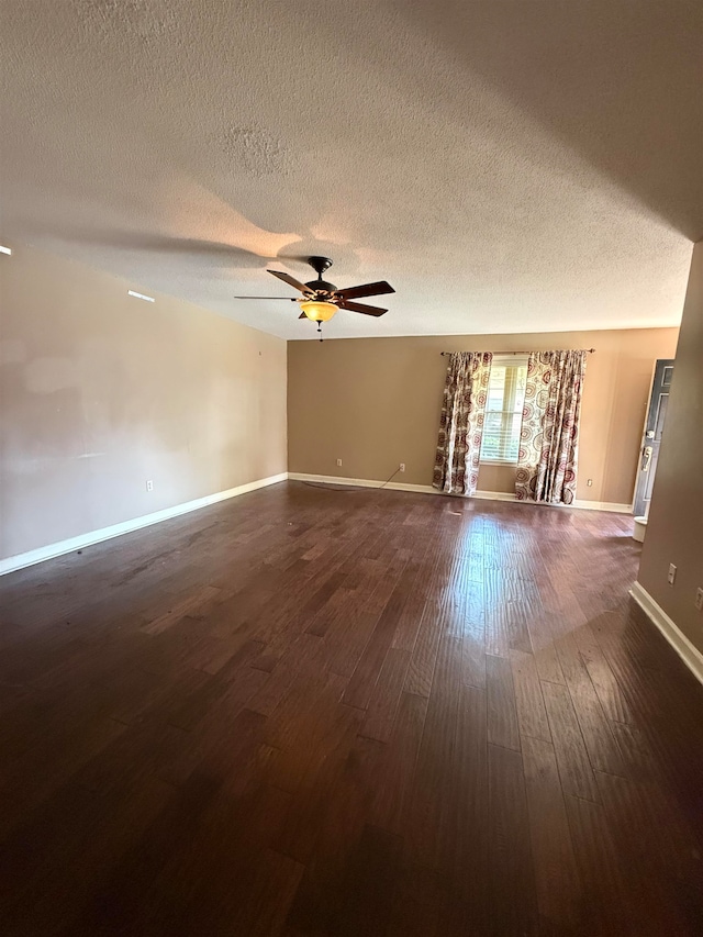 unfurnished room featuring dark wood-type flooring, ceiling fan, and a textured ceiling