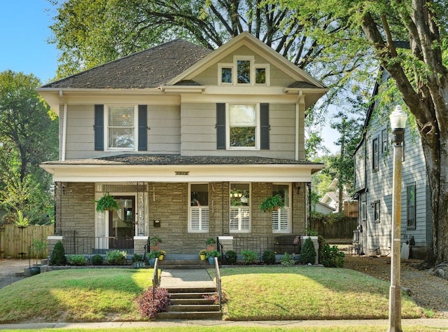 craftsman inspired home with a front yard and a porch