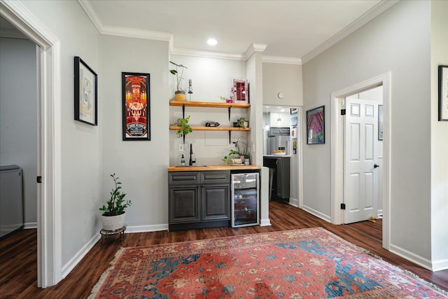 bar with crown molding, dark hardwood / wood-style floors, beverage cooler, and butcher block countertops