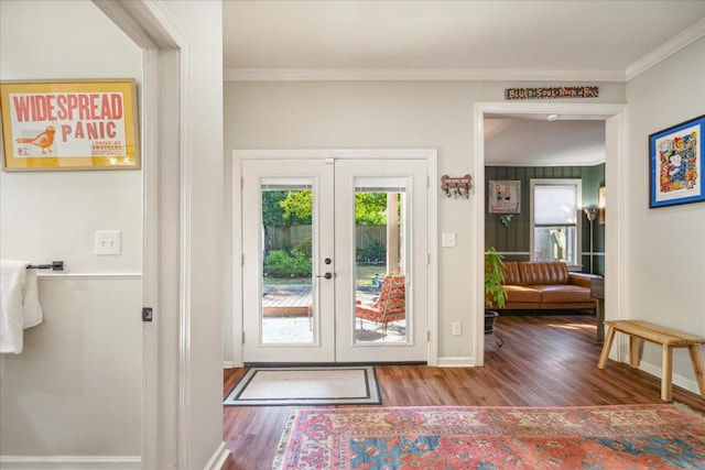 doorway with ornamental molding, french doors, and hardwood / wood-style floors