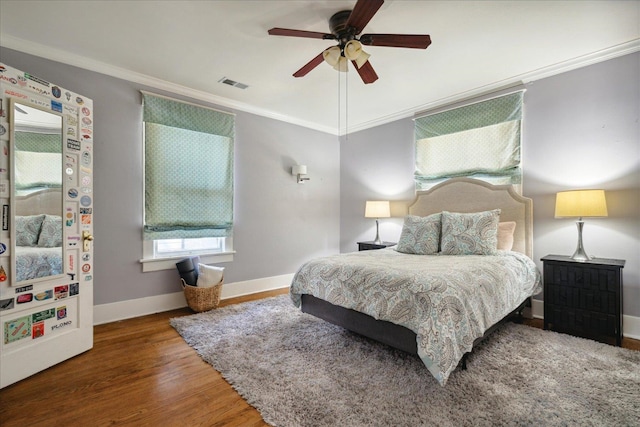 bedroom with crown molding, wood-type flooring, and ceiling fan