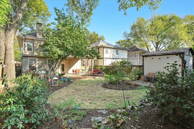 view of yard featuring a patio area and a storage unit