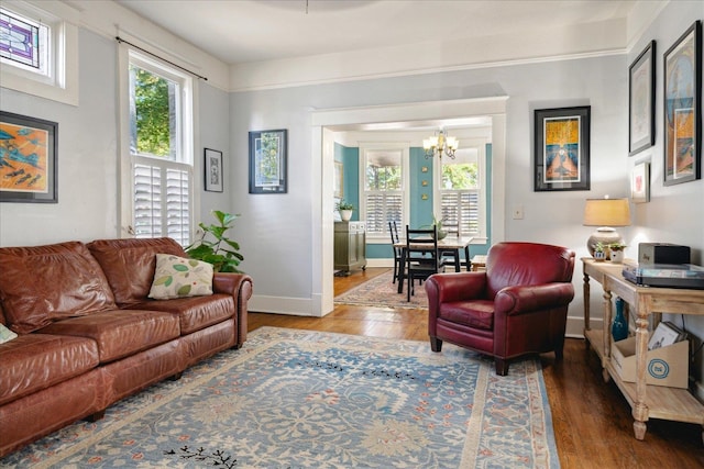 living room with wood-type flooring and an inviting chandelier