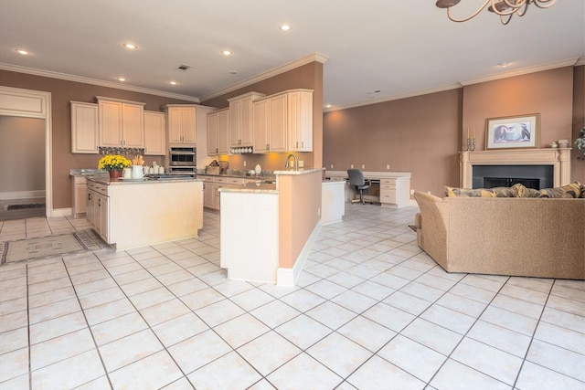 kitchen with built in desk, light tile patterned floors, stainless steel oven, ornamental molding, and cream cabinetry