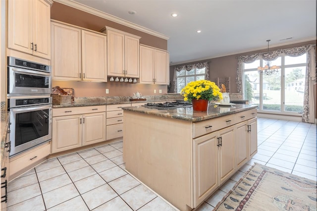 kitchen with stone counters, appliances with stainless steel finishes, a center island, pendant lighting, and crown molding