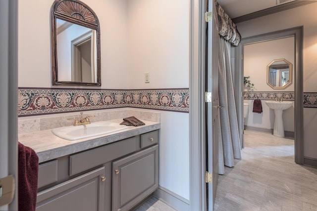 bathroom with vanity and crown molding