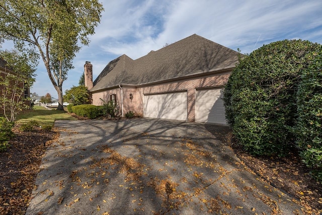 view of side of home with a garage