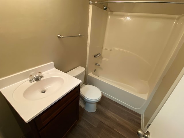 full bathroom with vanity, toilet, bathtub / shower combination, and hardwood / wood-style floors