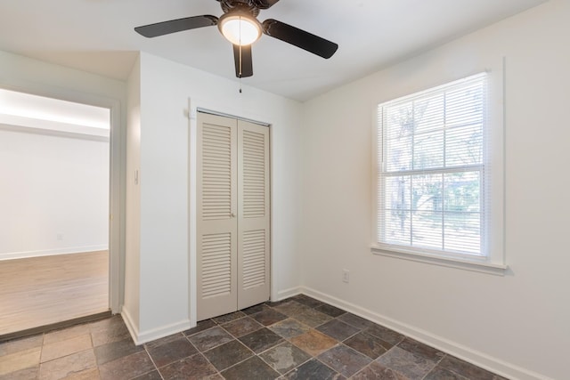 unfurnished bedroom featuring a closet and ceiling fan