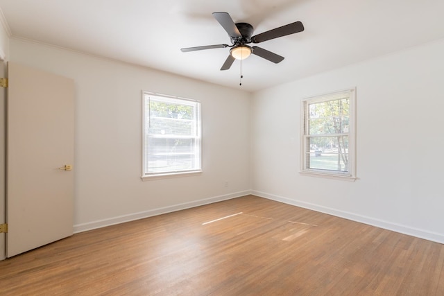 spare room with light hardwood / wood-style flooring, a healthy amount of sunlight, and ceiling fan