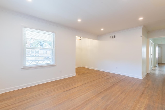 unfurnished room featuring crown molding and light hardwood / wood-style flooring