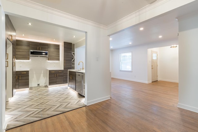 kitchen with light parquet floors, dark brown cabinets, appliances with stainless steel finishes, and decorative backsplash