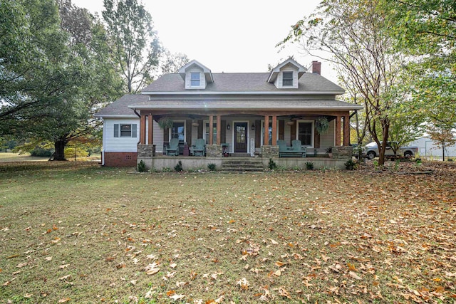 view of front of home with covered porch and a front yard