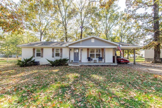 ranch-style house with covered porch and a carport