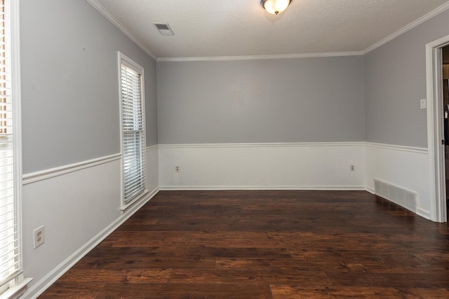 unfurnished room featuring ornamental molding, dark wood-type flooring, and a textured ceiling