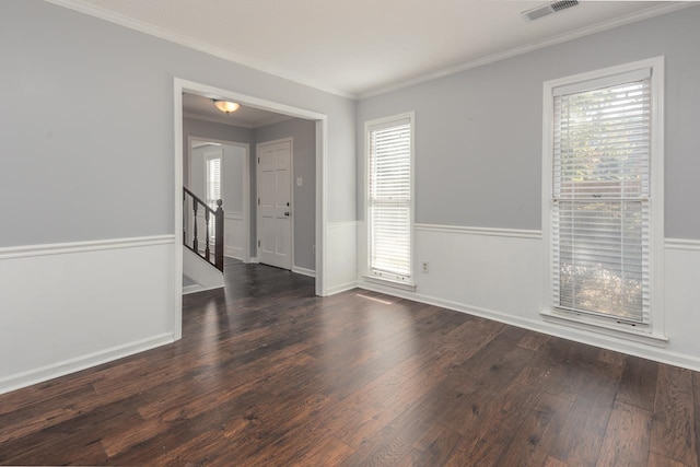 spare room featuring crown molding and dark wood-type flooring