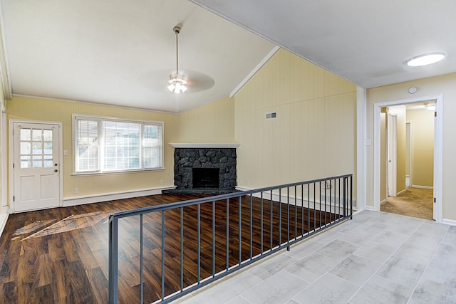 hallway with crown molding, lofted ceiling, a baseboard radiator, and hardwood / wood-style floors