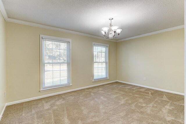 carpeted spare room featuring ornamental molding, a notable chandelier, and a textured ceiling