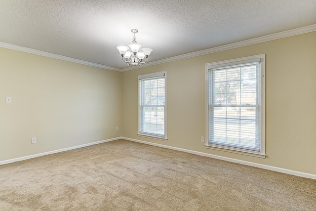 carpeted empty room with an inviting chandelier, a textured ceiling, and plenty of natural light