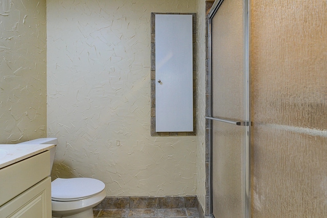 bathroom with vanity, toilet, and walk in shower