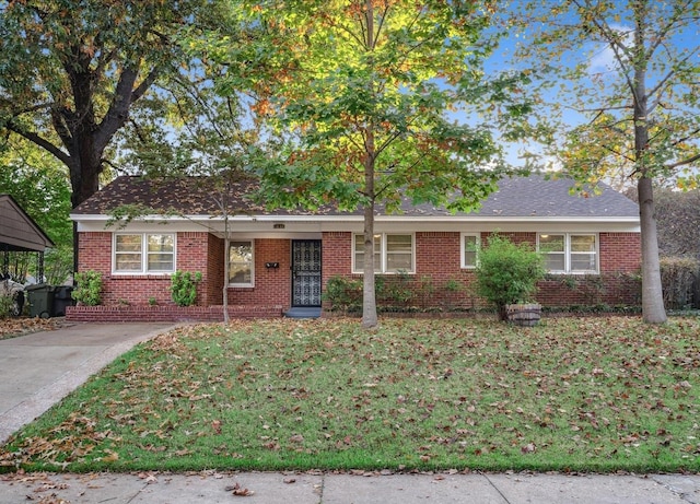 single story home with a front yard and a carport