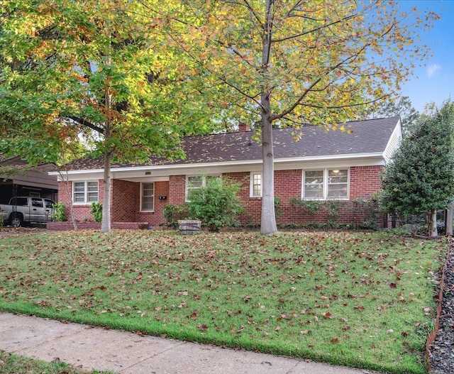 ranch-style home with a front lawn and a carport