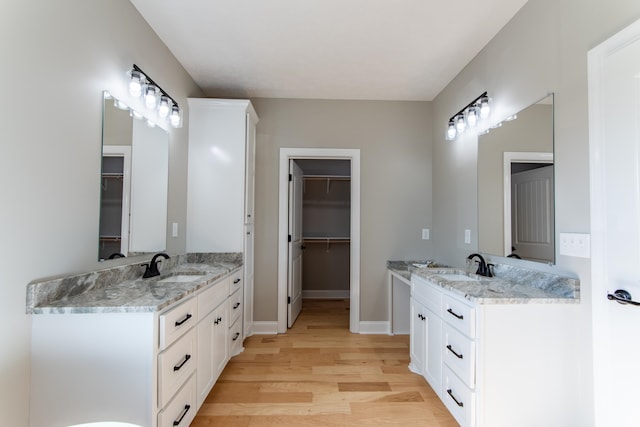 bathroom with vanity and hardwood / wood-style floors