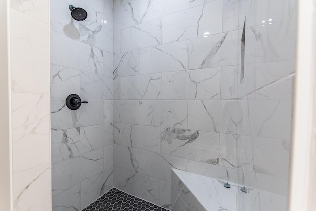 bathroom featuring a tile shower