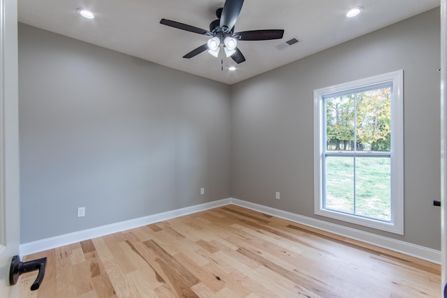 spare room with light hardwood / wood-style floors and ceiling fan