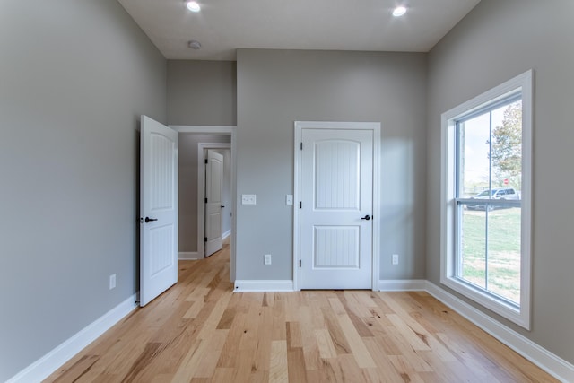 unfurnished bedroom featuring light hardwood / wood-style floors and multiple windows