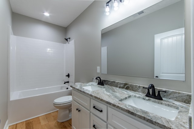 full bathroom featuring vanity, tub / shower combination, wood-type flooring, and toilet