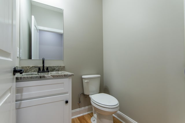 bathroom with vanity, hardwood / wood-style floors, and toilet