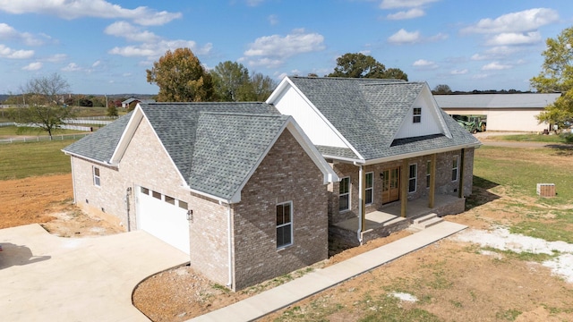 view of side of home with covered porch and a garage