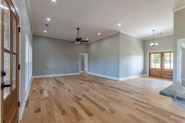 interior space with crown molding, ceiling fan with notable chandelier, and light hardwood / wood-style floors