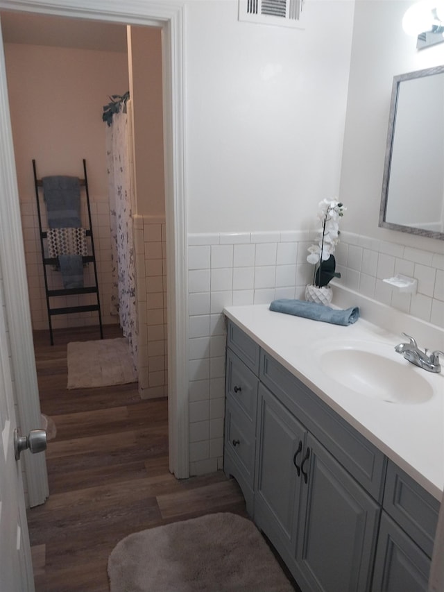 3811 Patte Ann Dr, Memphis, TN 38116 - bathroom with tile walls, vanity, wood finished floors, a wainscoted wall, and curtained shower
