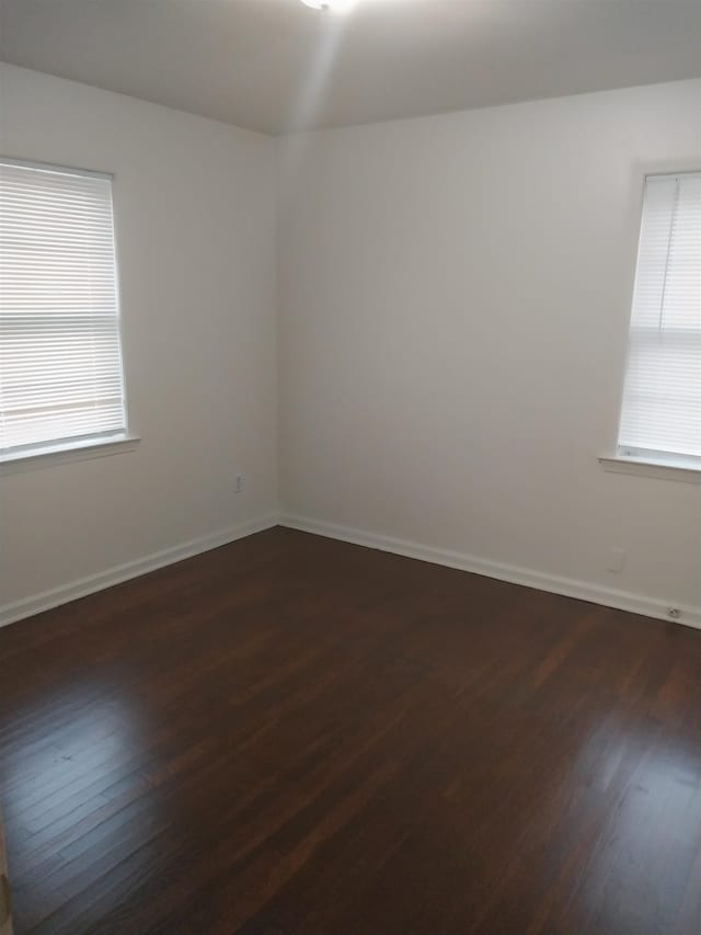 empty room with dark hardwood / wood-style floors