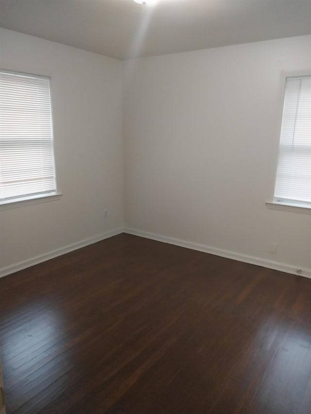 3811 Patte Ann Dr, Memphis, TN 38116 - unfurnished room featuring dark wood-style flooring, healthy amount of natural light, and baseboards